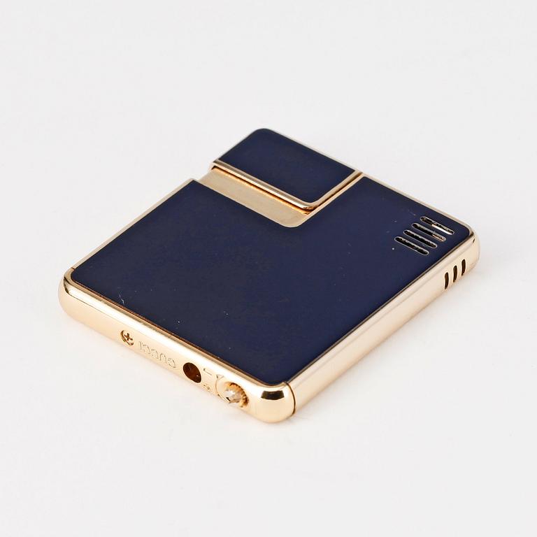 GUCCI, a lighter.