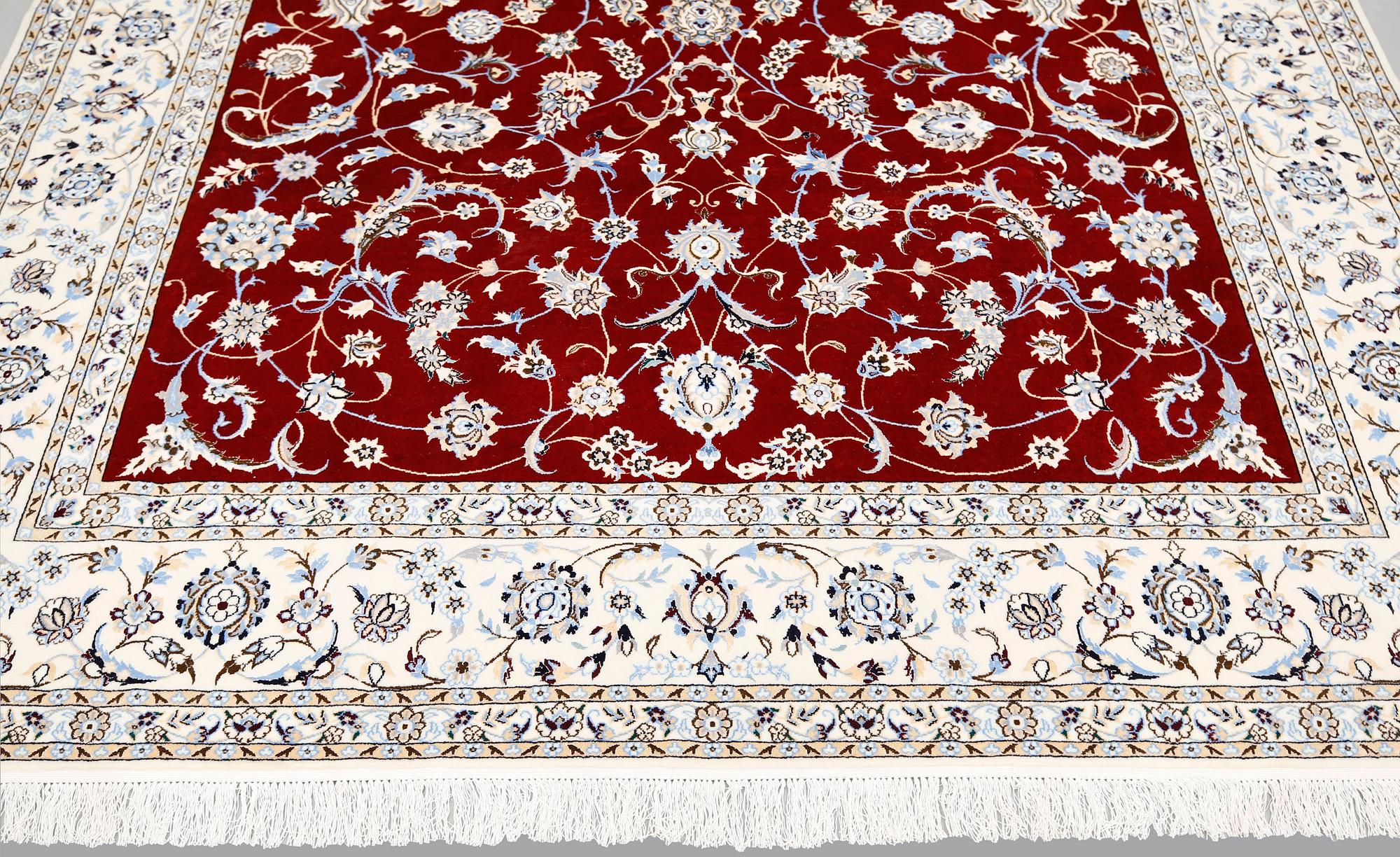 A Nain part silk carpet, 302 x 204 cm.