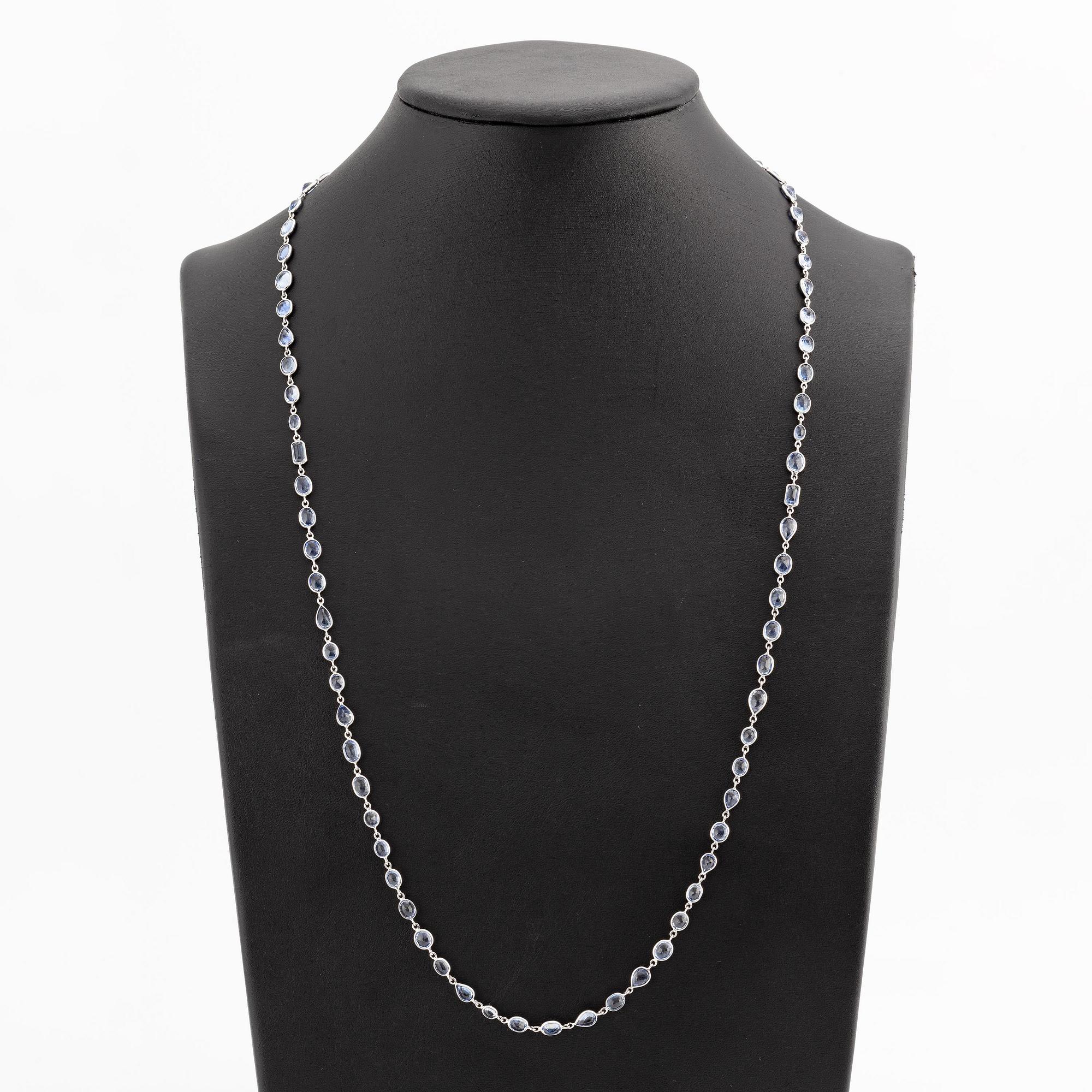 An 18K white gold necklace set  with faceted sapphires.