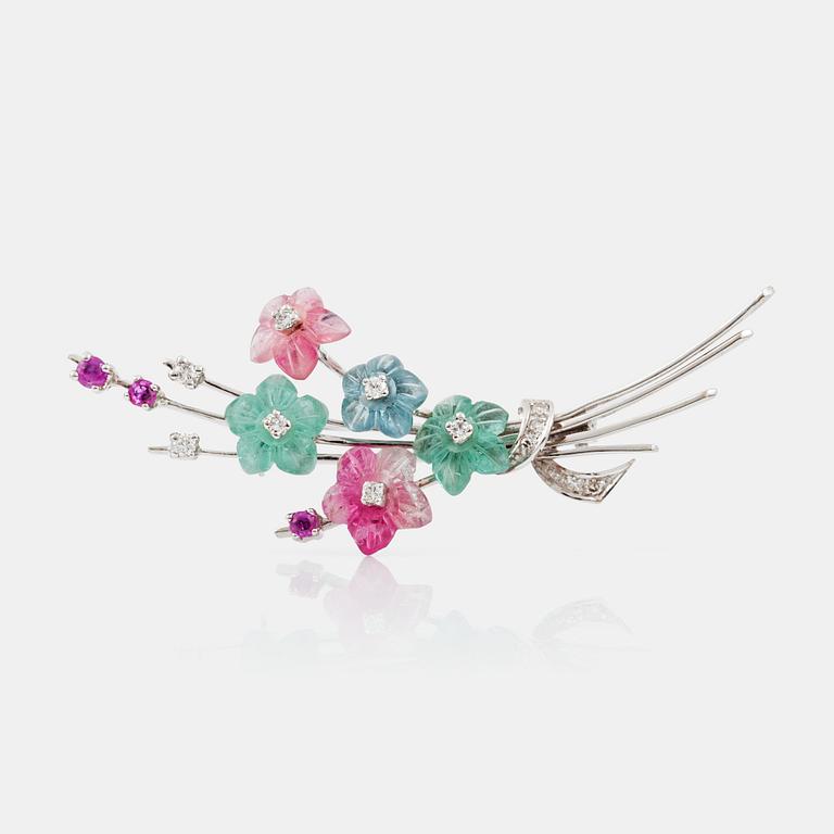 A pink tourmaline, aquamarine, pink sapphire and diamond brooch in the shape of a bouquet of flowers.