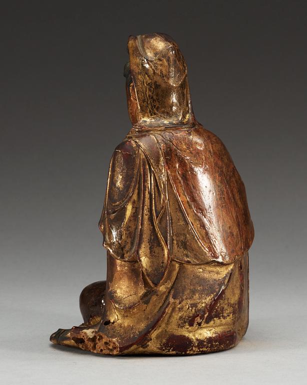 A gilt lacquer and wooden sitting figure of Guanyin, Ming dynasty (1368-1644).