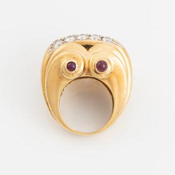 An 18K gold ring set with round brilliant-cut diamonds and cabochon-cut rubies.