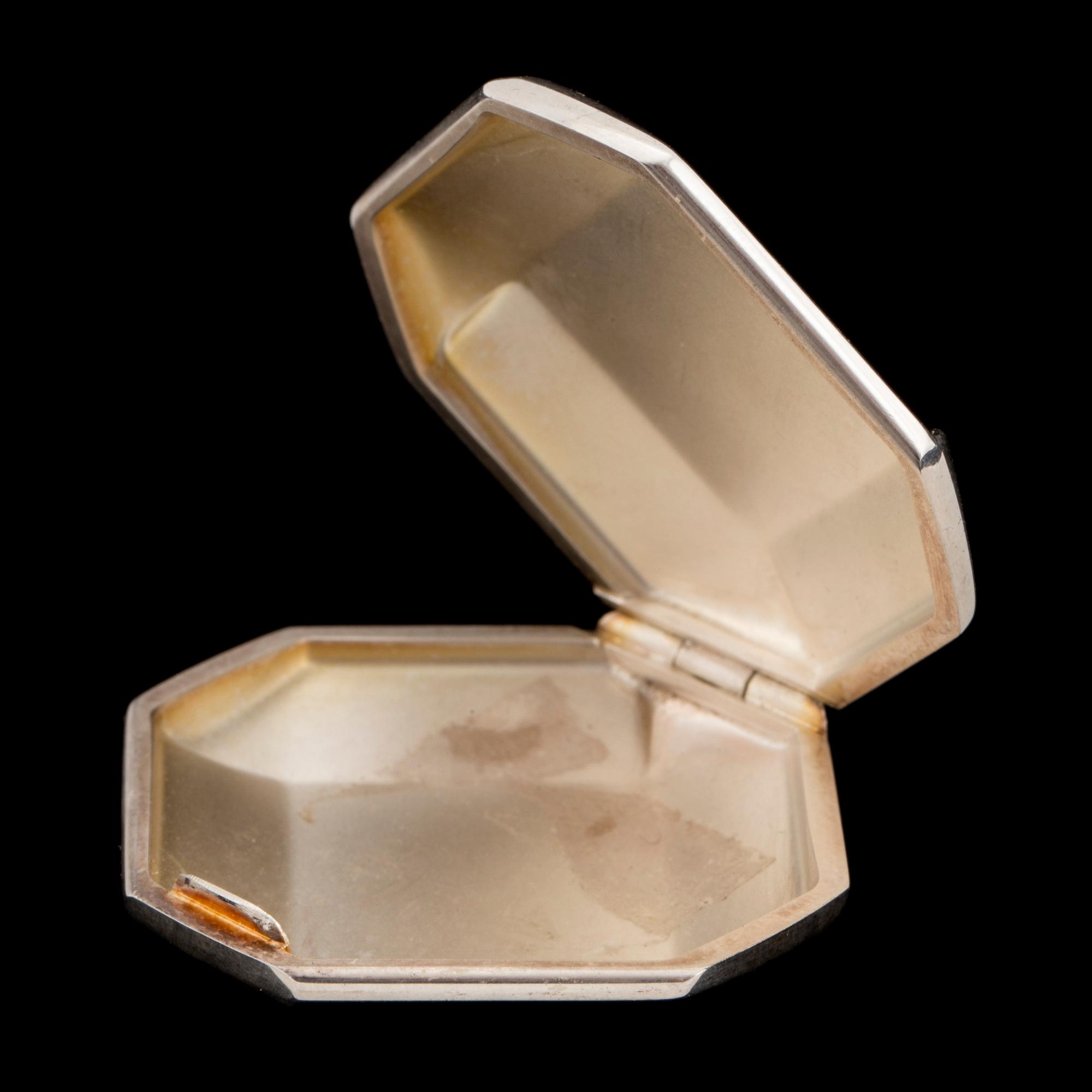 A silver Golf point, a box and two ball markers by Georg Jensen.