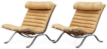 A pair of Arne Norell "Ari" brown leather and steel easy chairs by Norell.