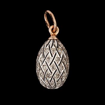 987. A pendant in the shape of an egg, surrounded by diamonds circa 0.30 ct.