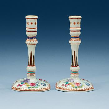 1596. A pair of famille rose candle sticks, Qing dynasty, Qianlong (1736-95).
