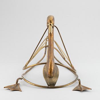 A 20th century grass newspaper stand in the shape of a swan.