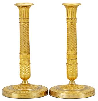 1044. A pair of Empire candlesticks.