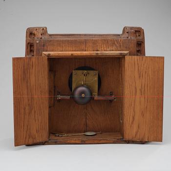 A Swedish Art Nouveau carved pine mantel clock, probably by Rackengruppen.