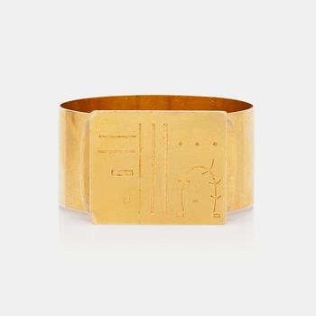 A gold bracelet with a signed and numbered Kandinsky plaque.