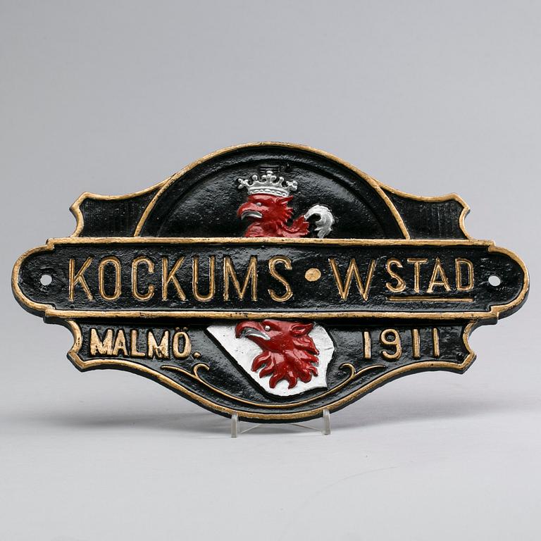 SKYLT, "Kockums Wstad Malmö 1911", gjutjärn.