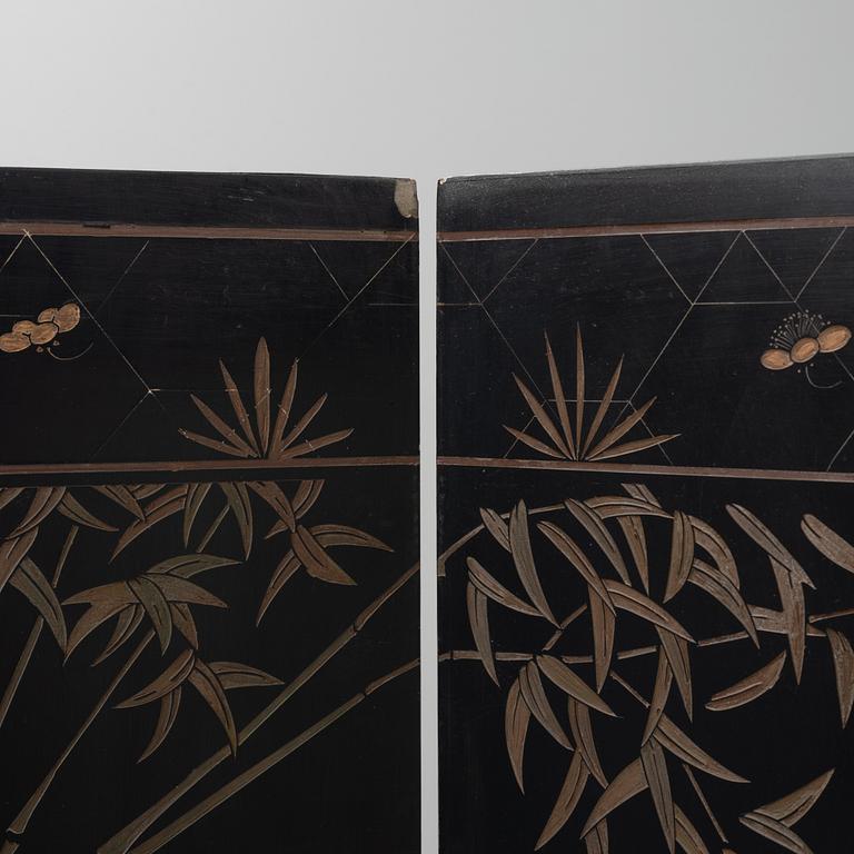 A Chinese lacquer folding screen, 20th century.