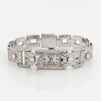 A bracelet/watch in platinum and 18K white gold set with old- and eight-cut diamonds.