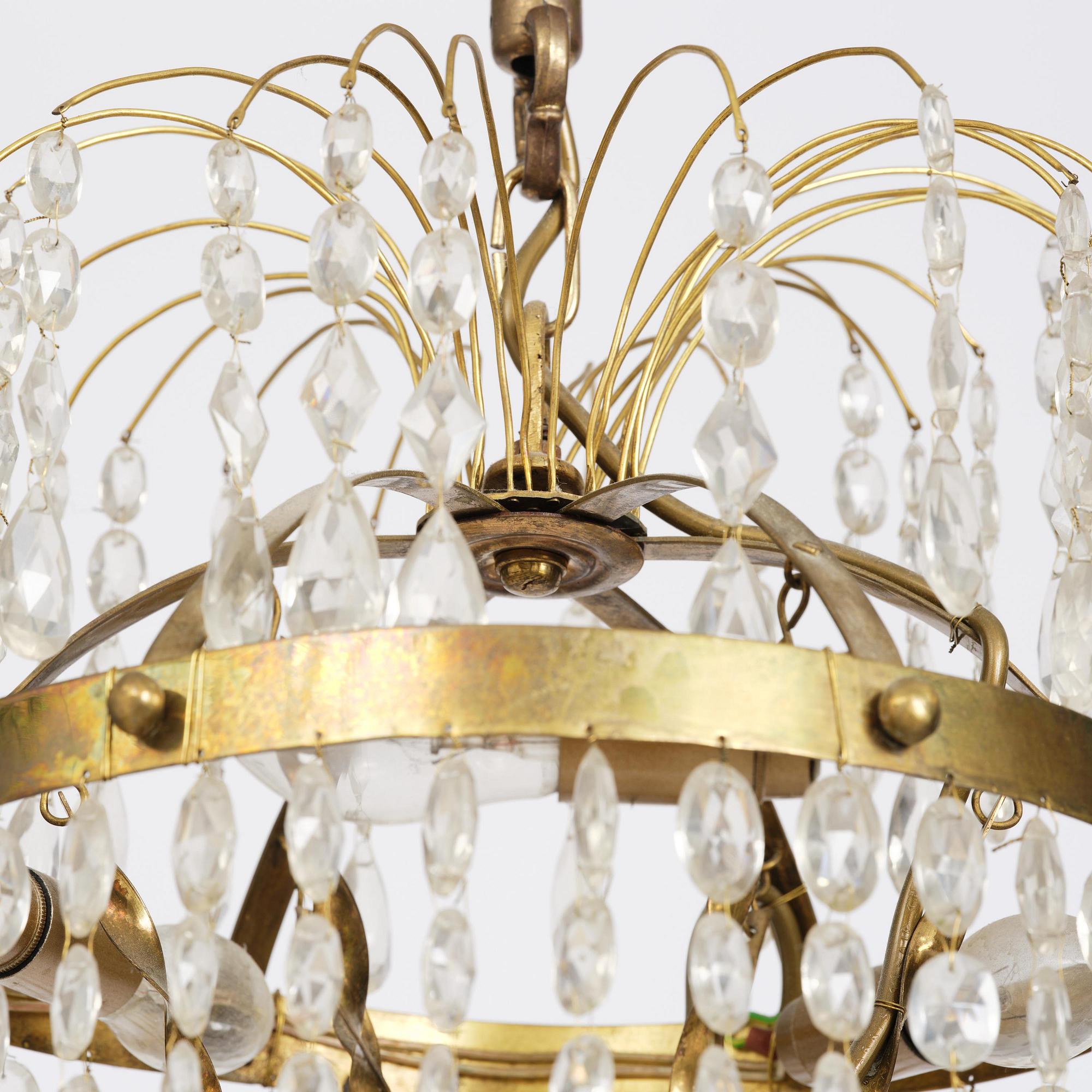 A Swedish gilt brass and cut glass thirteen-light Empire chandelier, early 19th century.