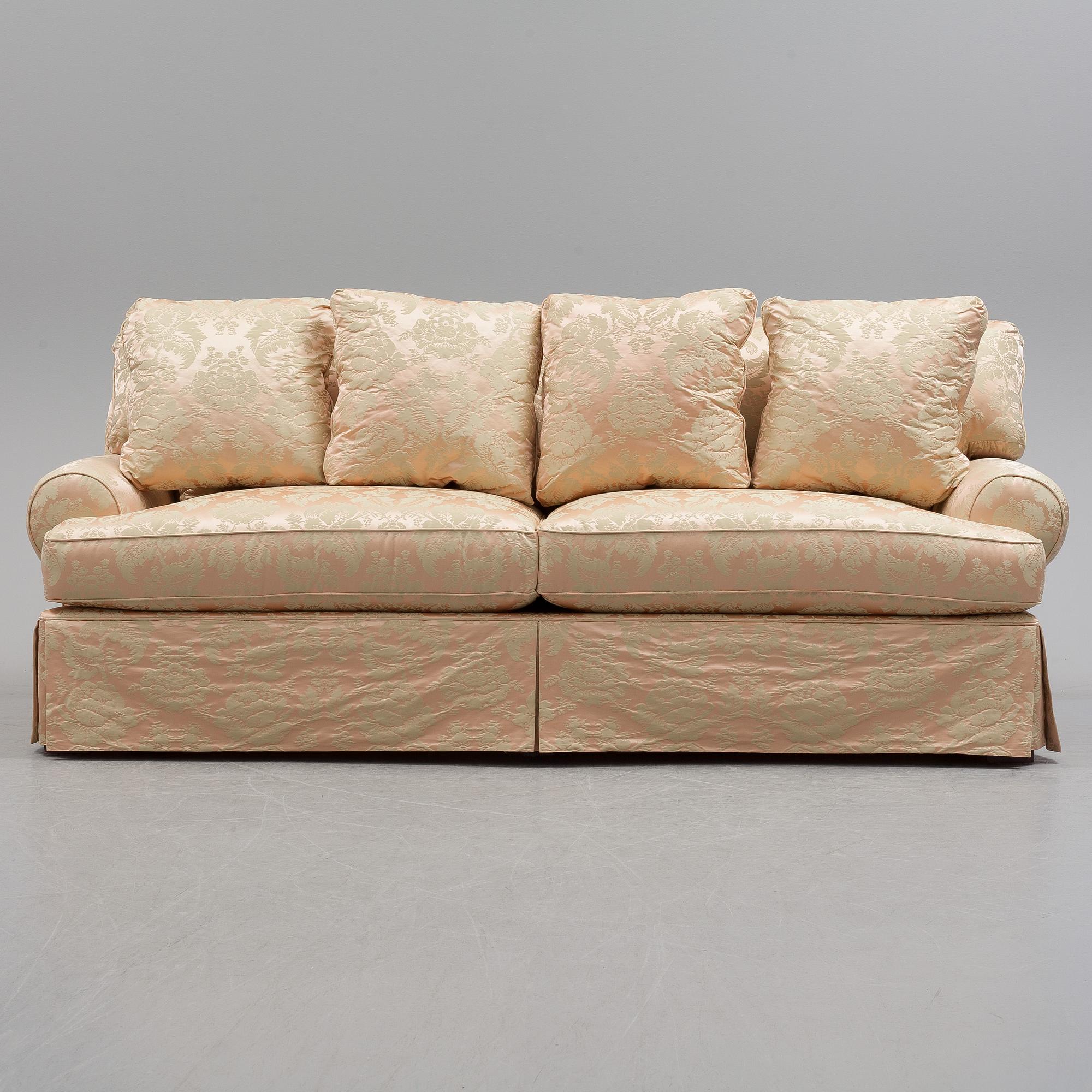 A sofa upholstered with silk damask.