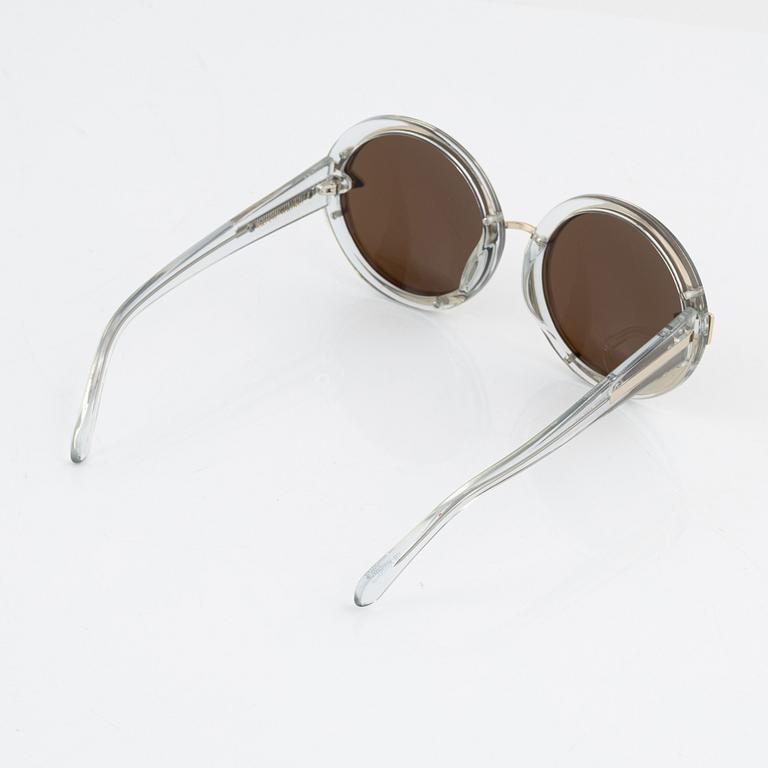 Karen Walker, a pair of "Orbit" sunglasses.