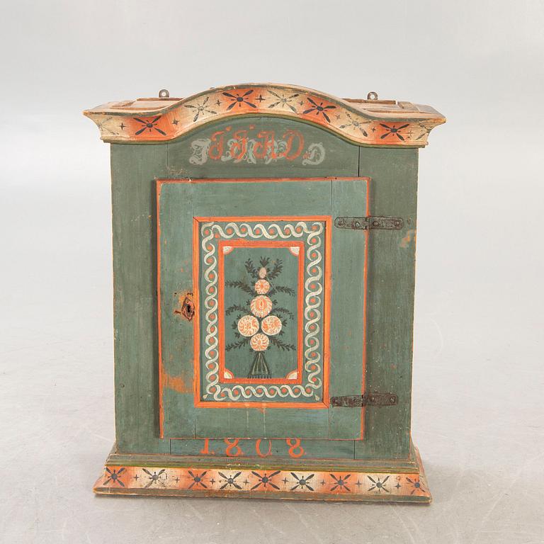 A painted Swedish wall cabinet dated 1808.