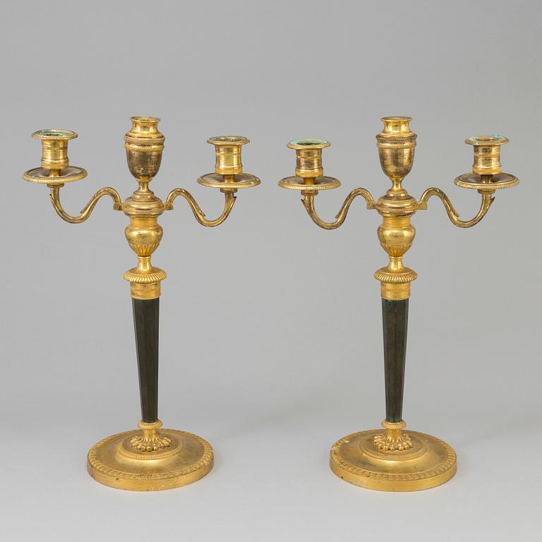 A pair of French Directoire late 18th century ormolu candelabra for three candles.