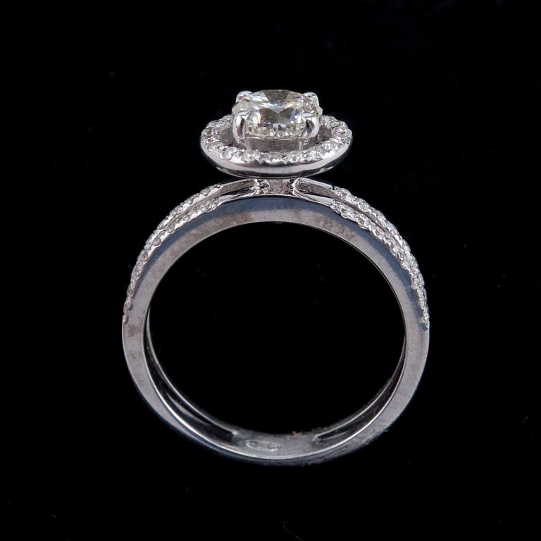 A RING AND A PAIR OF EARRINGS, brilliant cut diamonds. 1.00 ct + 0.35 ct. in ring. 0.80 ct. in earrings.