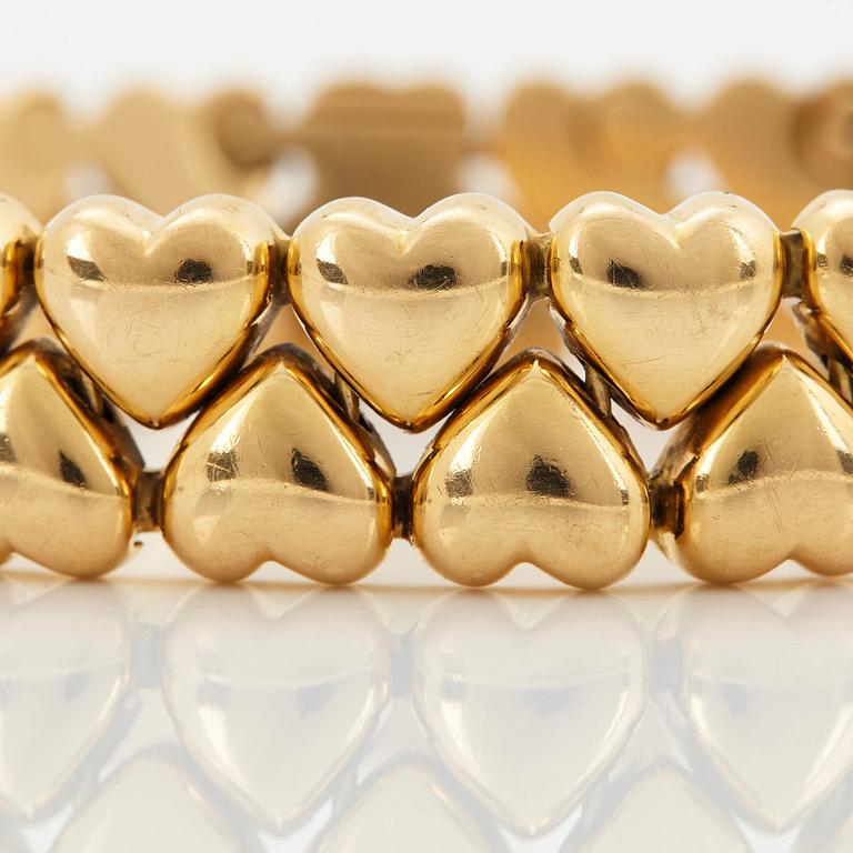 A Cartier 18K gold "Double Hearts" bracelet.