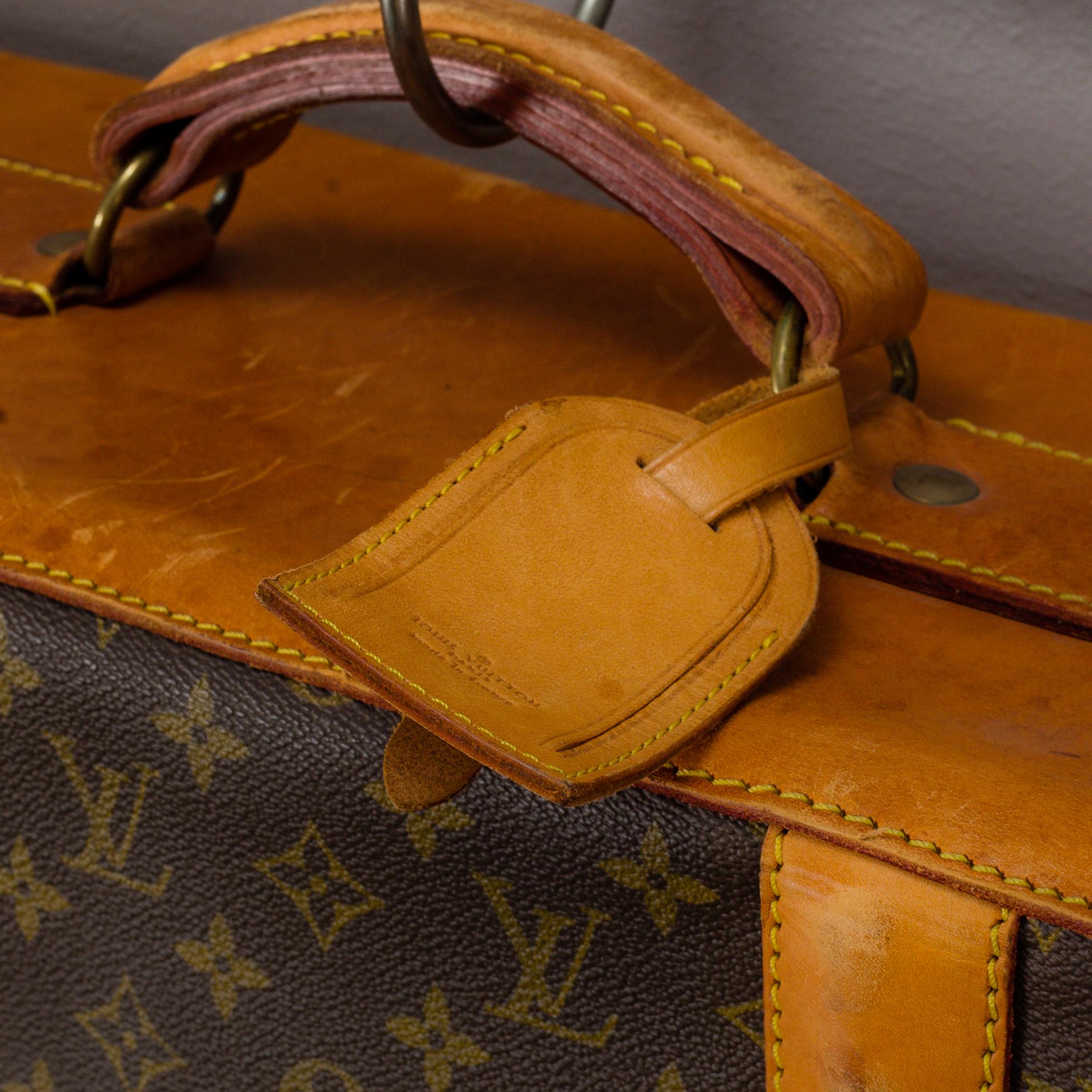 A Louis Vuitton vintage Monogram Canvas Homme Garment Bag.