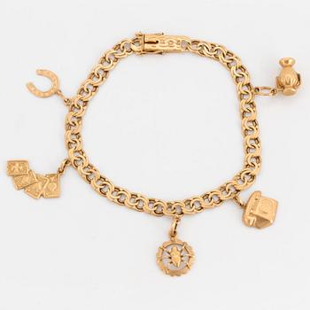 An 18K gold charm bracelet.