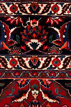 A SIGNED MESHED RUG, 392 x 305 cm.
