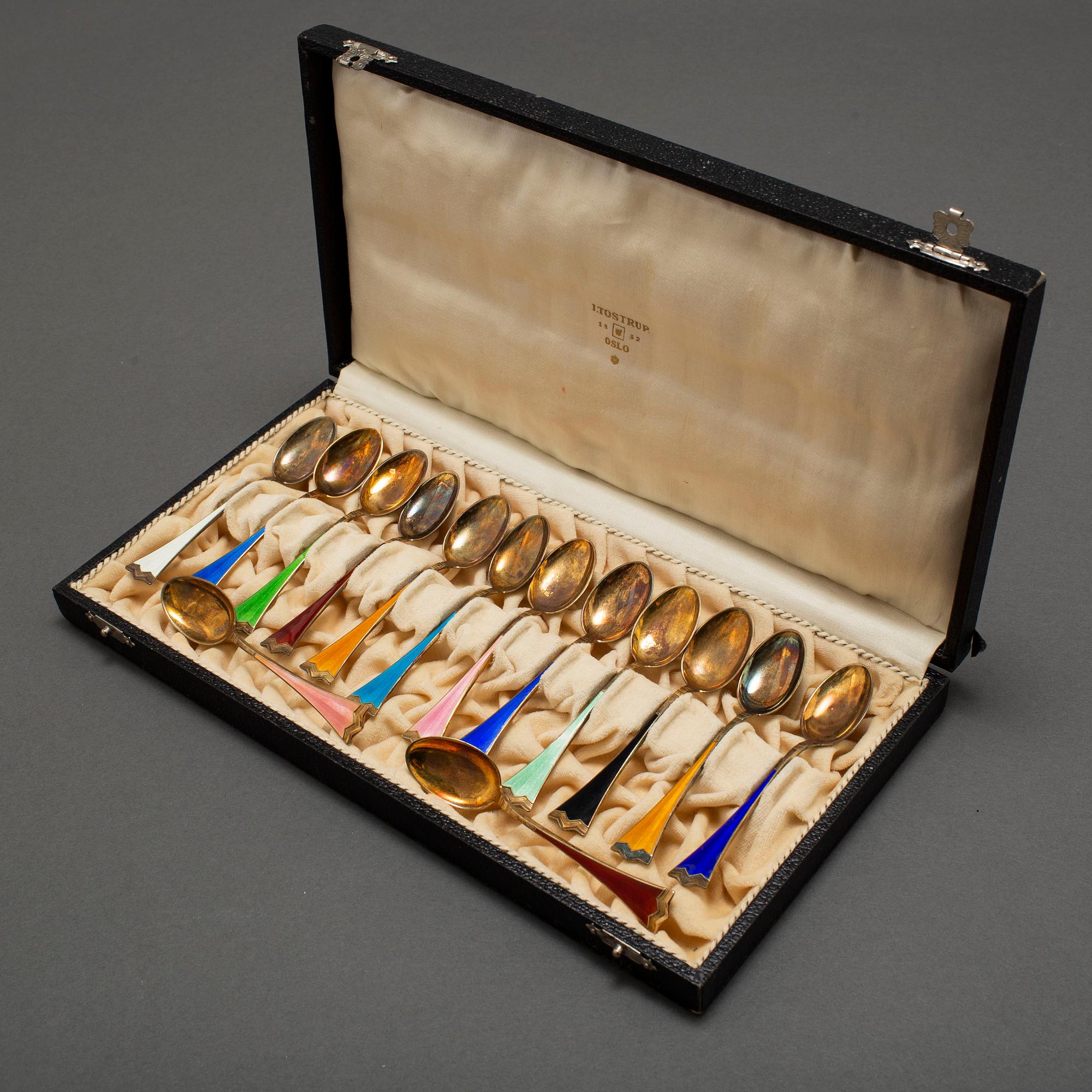 J TOSTRUP, 14 silver gilt and enamel coffee stoons from Oslo, Norway.