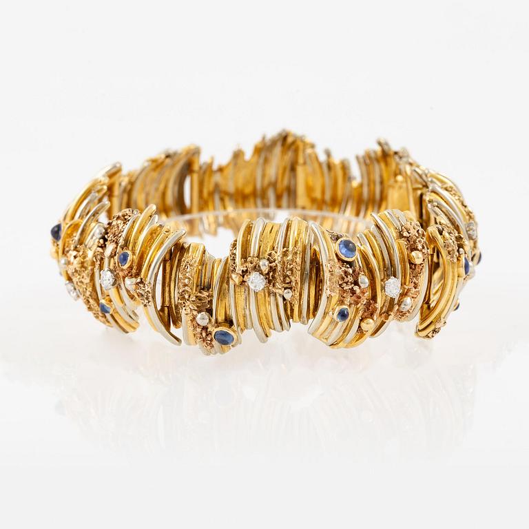 An 18K gold bracelet set with round brilliant-cut diamonds and cabochon-cut sapphires.