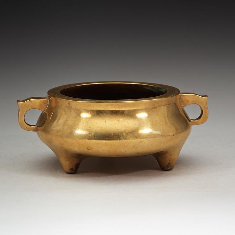 A polished bronze tripod censer, Ming dynasty (1368-1644).