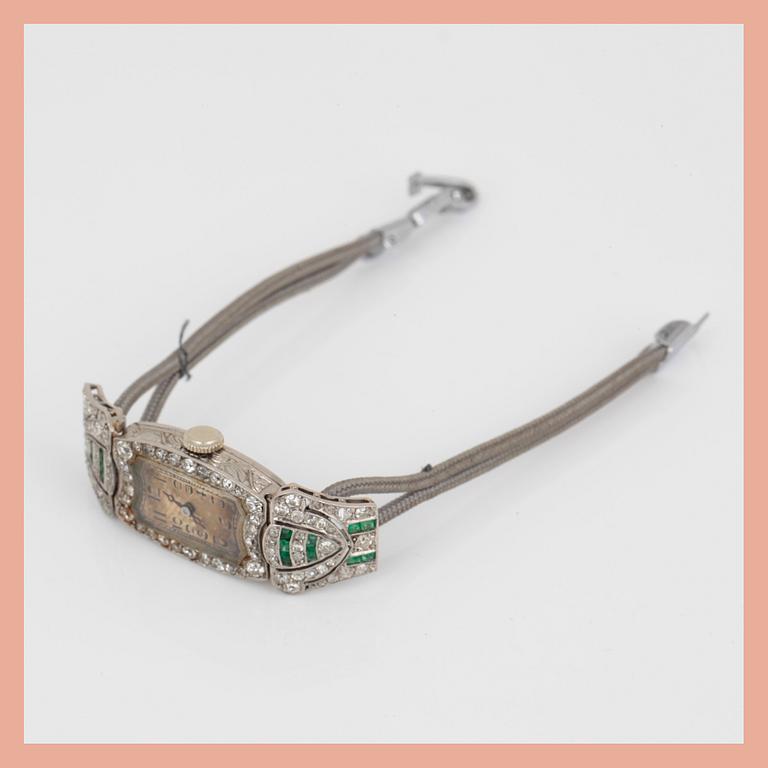 ARMBANDSUR, Art Deco, silver med åttkantslipade diamanter, tot ca 0,74 ct och smaragder. Total vikt ca 15 g.