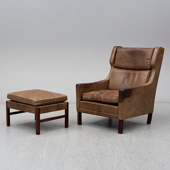 A 1960s easy chair and foot stool.