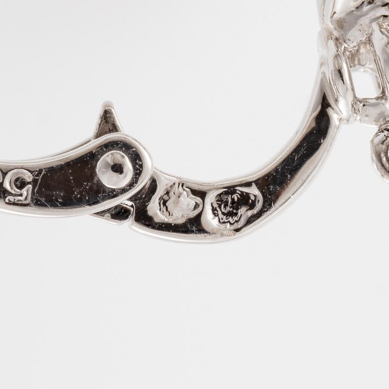 Cartier a pair of earrings platinum set with drop-shaped and round brilliant-cut diamonds.