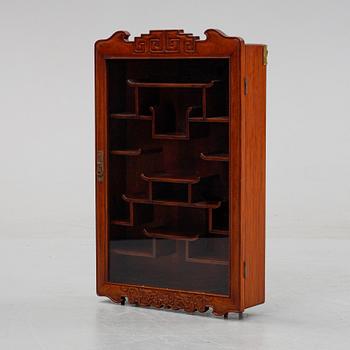 A Chinese hardwood hanging display cabinet, 20th century.