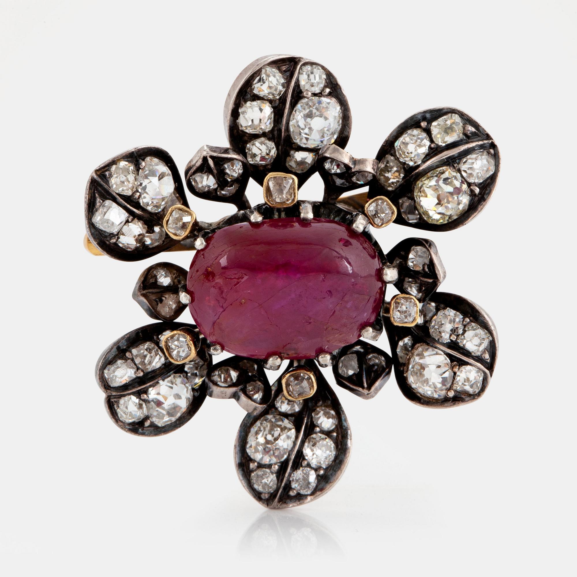 Brosch med en cabochonslipad rubin ca 4.00 ct och gammalslipade diamater.
