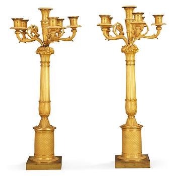 602. A pair of French Empire early 19th century six-light candelabra.