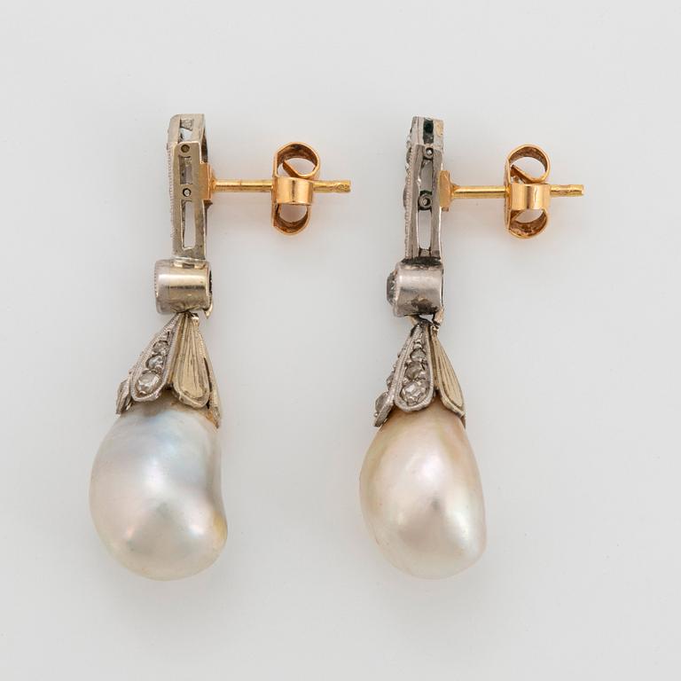 A pair of platinum and 18K gold pearl earrings set with old-cut diamonds.