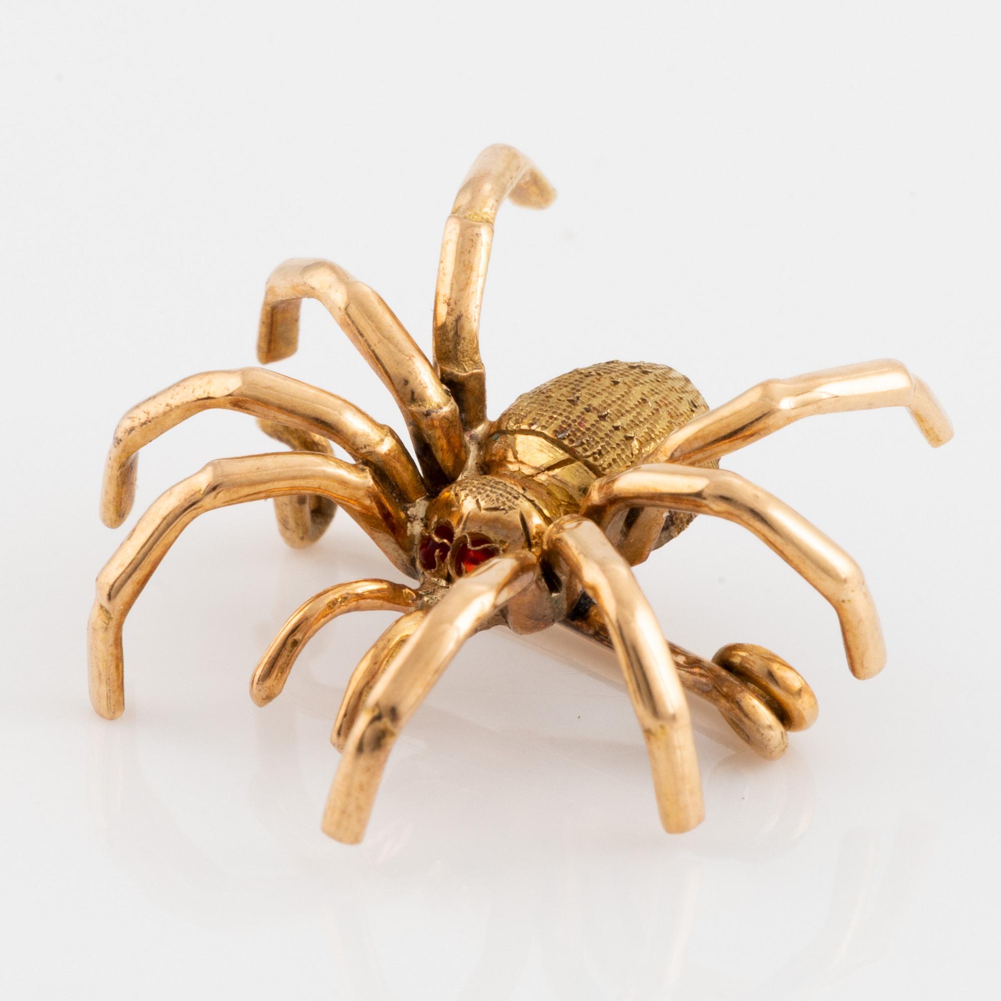 Gold spider brooch.