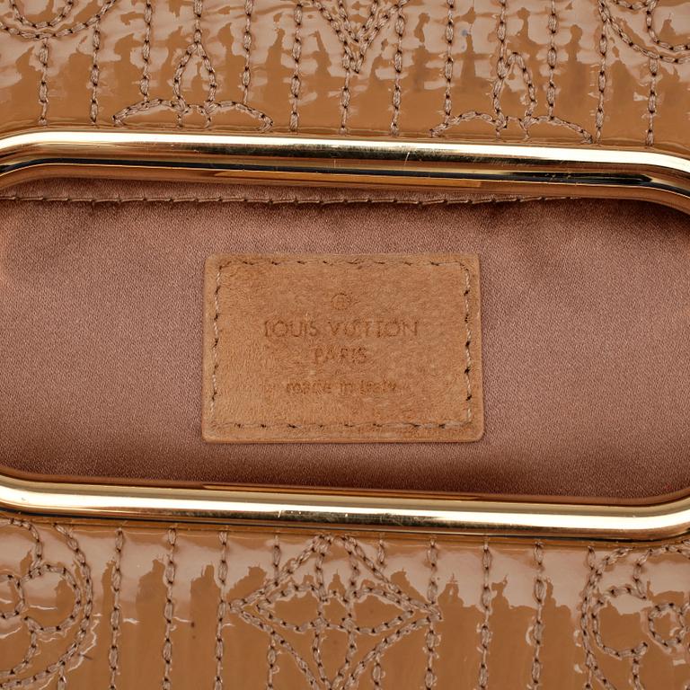 LOUIS VUITTON, a beige suede monogrammed clutch with patent details.