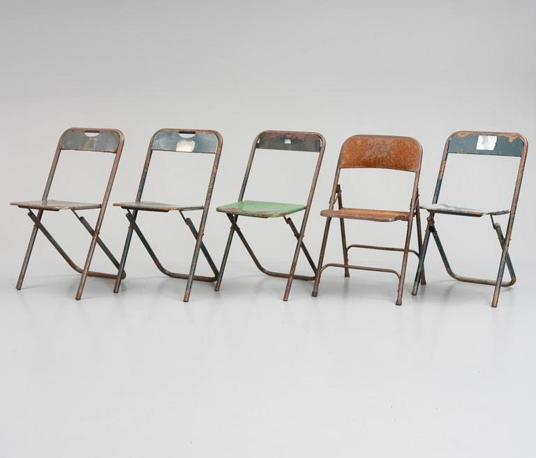 A set of five folding chairs.