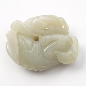 A nephrite sculpture of a reclining buddhist lion with its cub, presumably late Qing dynasty.