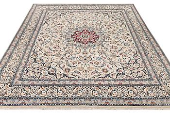 A Nain carpet, part silk, 9 laa, c. 390 x 295 cm.
