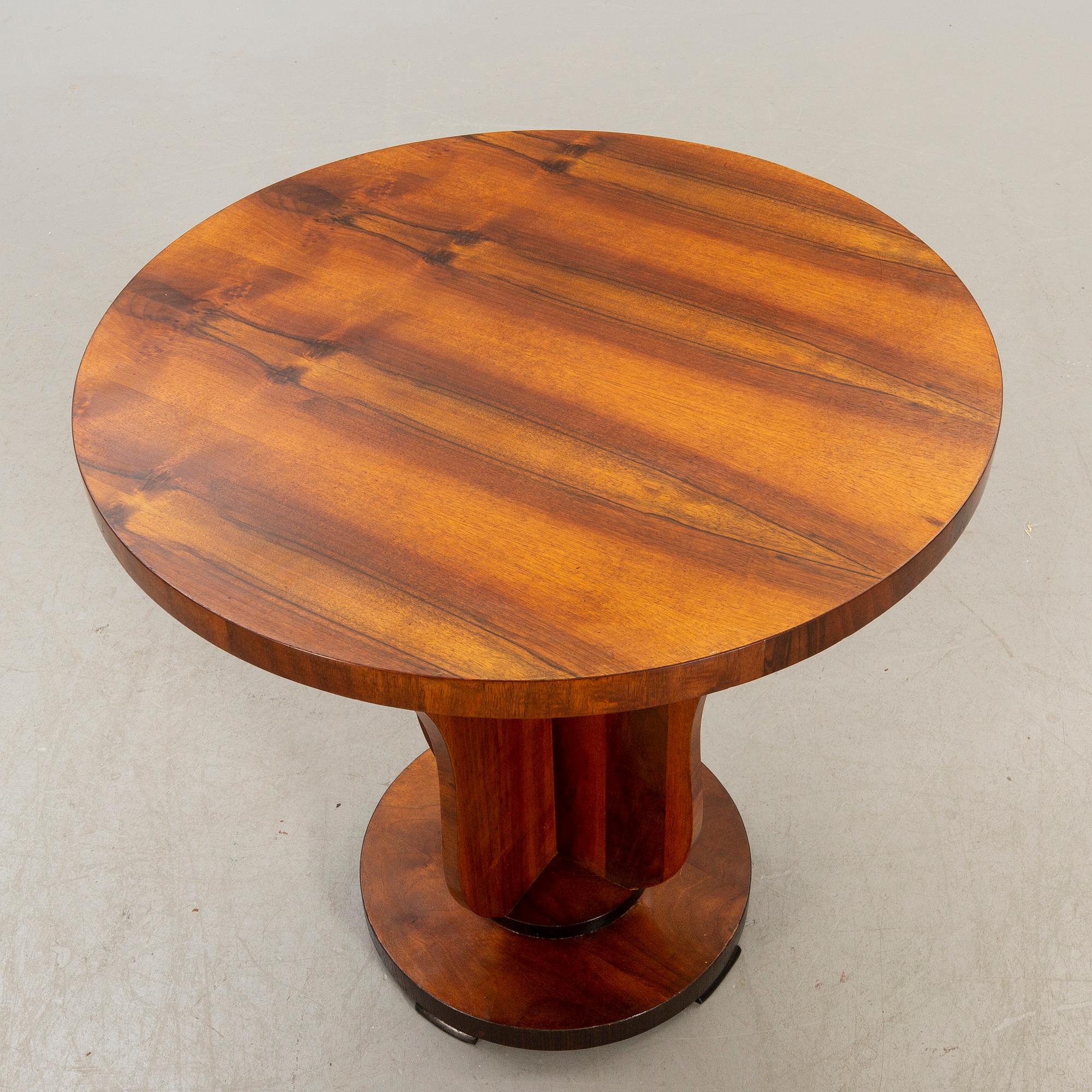 An Art deco style walnut table later part of the 20th century.