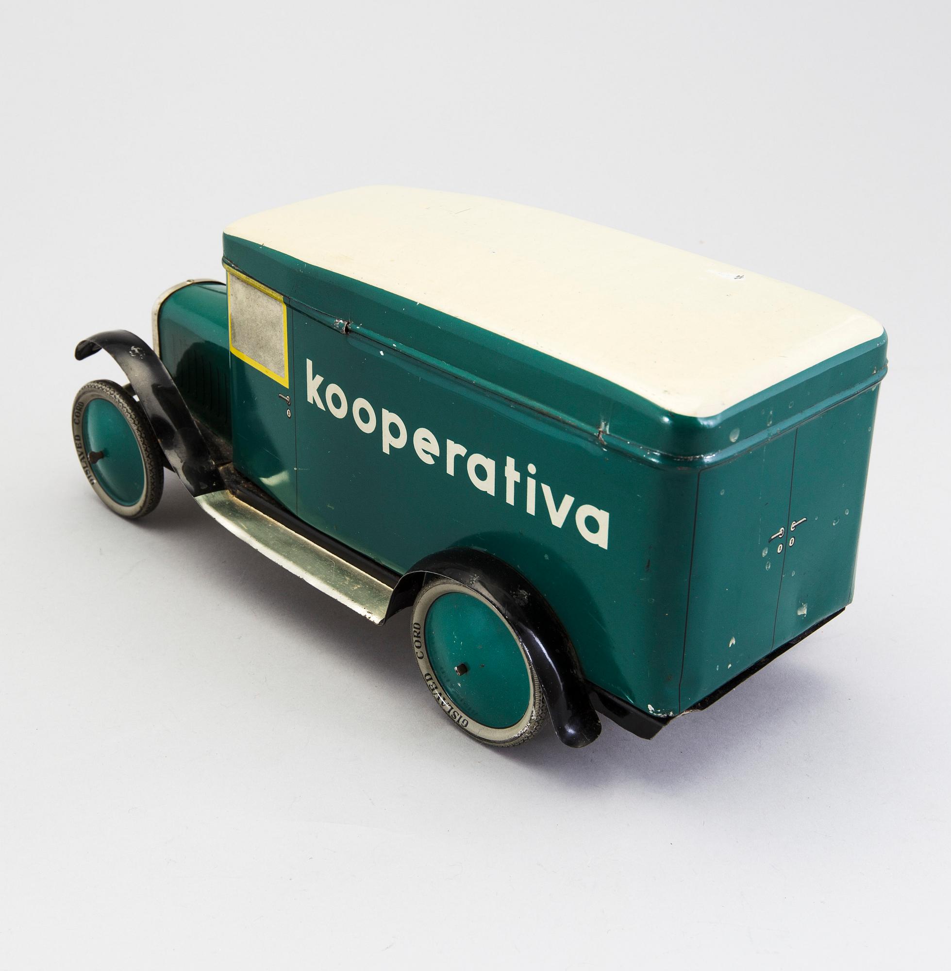 A tinplate biscuit jar in the shape of a truck 1930s.