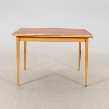 A 1960s teak and beech dining table.