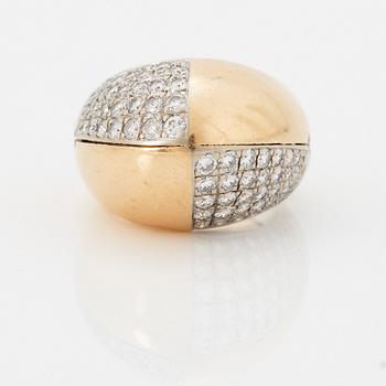 A Paul Binder ring in 18K gold set with round brilliant-cut diamonds.