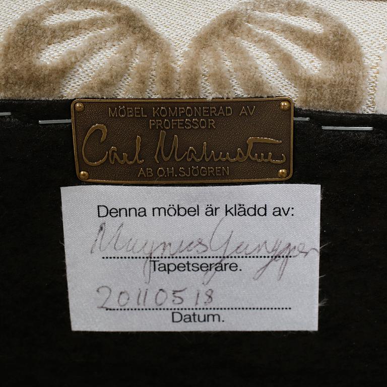 An armchair named "Rundrygg", designed by Carl Malmsten and made by OH Sjögren in 2011.