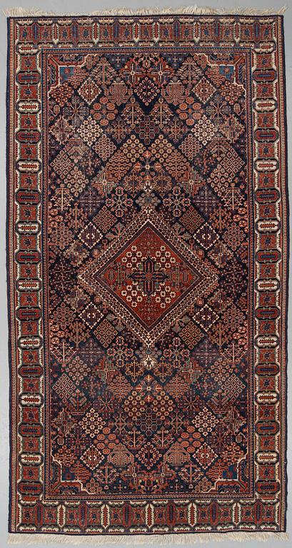 A semi-antique carpet from Joshaghan, around 348 x 190 cm.
