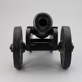 A 20th century cast iron model cannon.