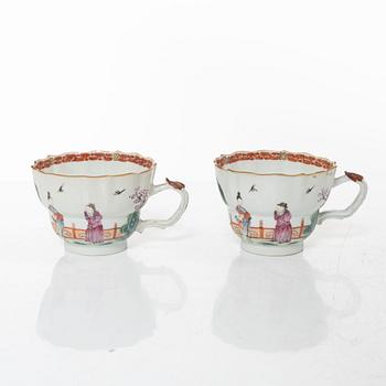 A pair of Chinese famille rose teacups with saucers and a pair of plates and two dishes, Qing dynasty, 18th century.